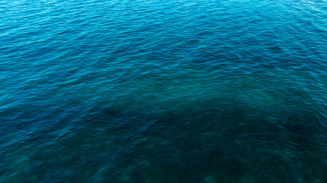Top view of deep blue sea water surface with small ripples, aerial drone shot of turquoise ocean texture at island , abstract nature background	
