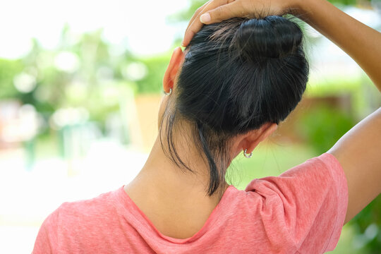 Women have neck pain, shoulder pain, at the park health concept.	
