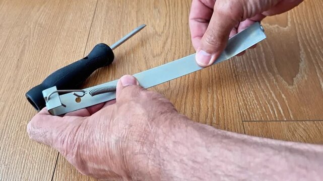 A metal plate is carefully bent using a spring clamp to maintain steady pressure and improve alignment. Ideal footage for manufacturing, metalworking, fabrication, engineering, and DIY themes