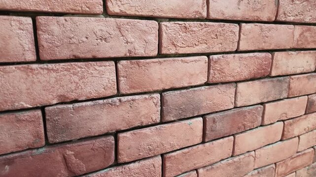4K Red Brick Wall Texture Background.Angled rustic masonry surface with rough details and ample copy space.