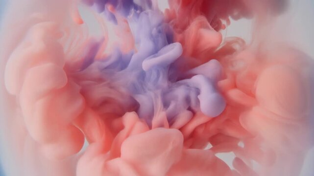 Watercolor pigment blooms through clear water as soft coral and lavender hues unfurl into organic cloudlike formations under gentle overhead lighting with elegant cinematic macro motion.