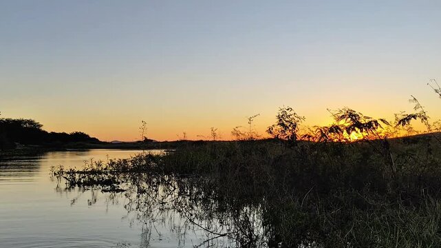 Golden Sunset Over Calm River and Marshland