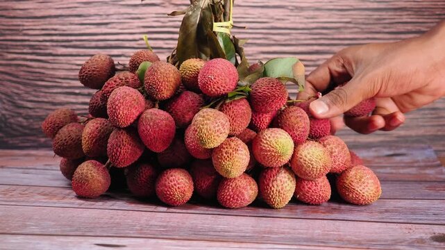 Litchi fruit pile on wooden table