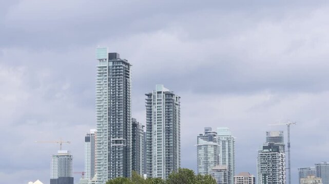 Modern skyscrapers with cloudy sky background in Vancouver Canada, background establisher skyline