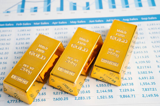 Gold bars on US dollar banknote money, finance trading investment business currency.