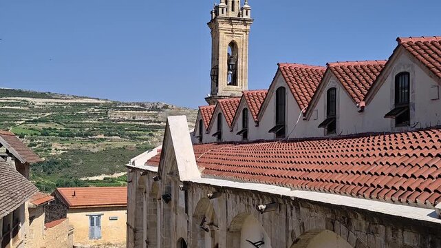 Exterior View Of The Historic Holy Cross Monastery In Omodos Village Cyprus Showing The Bell Tower And Red Tiled Roofs Under A Bright Clear Sky