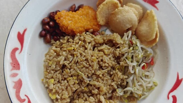 Indonesian Nasi Goreng Fried Rice Served with Crackers, Peanuts, and Bean Sprouts