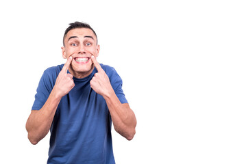 Fototapeta premium Man with two fingers to his lips showing a smile