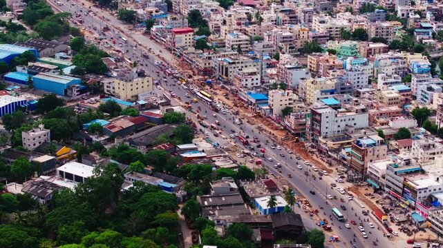 City traffic with national highway 65 and Residential buildings at Lingampally, chanda nagar, hyderabad, telangana, india. day time, stable shot, drone shot, 4k.