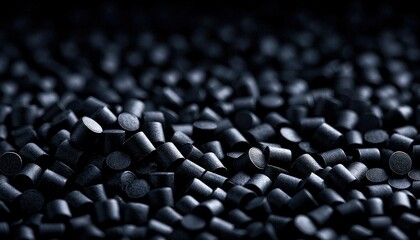 Fototapeta premium Dark, granular material fills the frame, creating a textured, abstract background