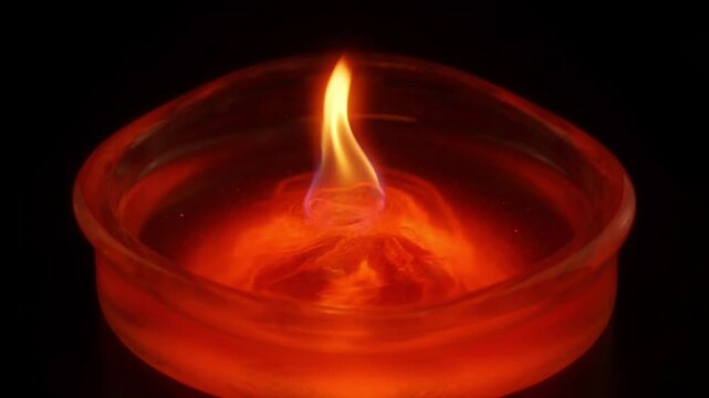 Cinematic candle flame glow dark background orange fire abstract closeup wax heat warm light minimal design moody atmosphere detail macro intense focus art reflection glass bowl spiritual calm