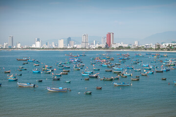 Obraz premium Aerial view of the skyline of Da Nang fishing port, Vietnam, with its basket boats.