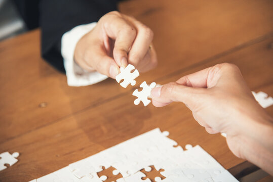 Business jigsaw puzzle connections strategy synergy team solution. Stakeholders business trusted communicate teams hands holding jigsaw puzzle synergy. Implement puzzle communication solve synergy