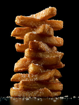 Thick-sliced ​​potato chips seasoned with salt are stacked high