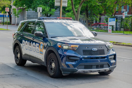 Montreal, Quebec, Canada. July 26, 2026. Front three quarter view of SPVM police SUV vehicle parked on city street.