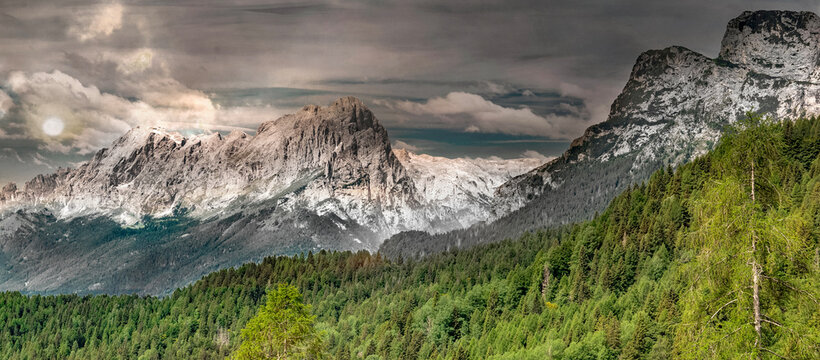 Dolomites mountain in Italy south of Tyrol, with famous rocky peaks background under cloudy sky at sunset