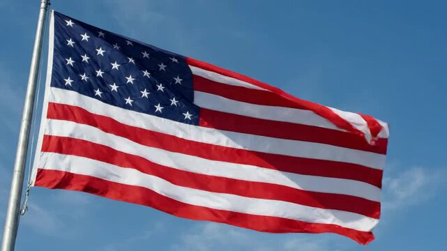 American flag waving proudly against a clear blue sky, patriotic symbol of the united states of america for national holidays and memorial png. ai generated