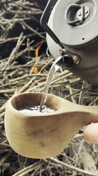 Cozy Campfire Brew: Steaming Water in a Wooden Kuksa