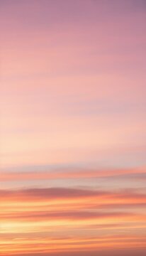 Pastel Sunset Sky: A serene and breathtaking view of a sunset sky painted with soft pastel hues of pink, orange, and lavender, creating a tranquil and dreamlike atmosphere.