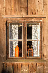 Rustic wooden croft window with lace curtains © Lars Johansson