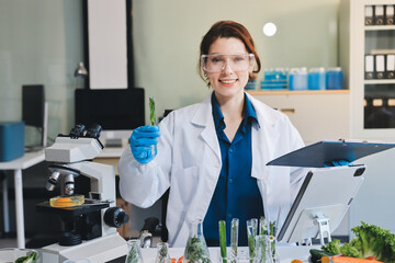 Fototapeta premium Scientists in lab coats work with plants in a modern lab, focusing on research and experimentation under bright, sterile conditions.