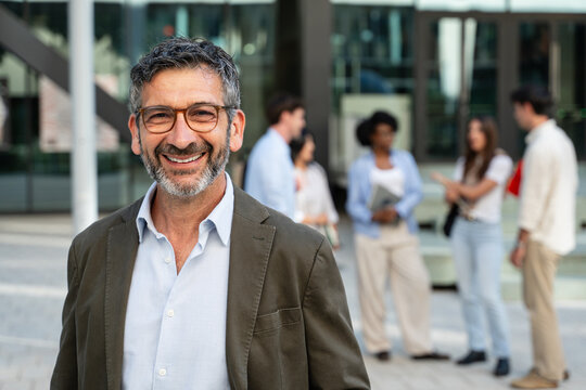 Portrait of male Professor smiling Outside University Building