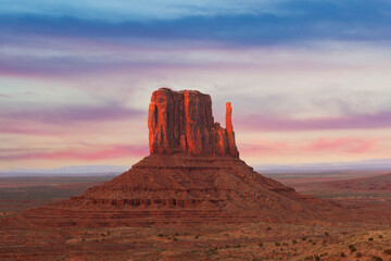 Monument Valley Butte Silhouette at Sunrise with Desert Mist and Vibrant Dawn Sky, Arizona, Utah, USA © somchaij