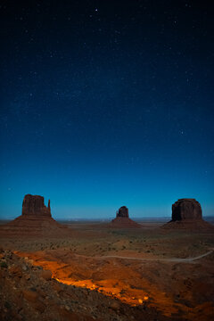 Monument Valley Butte Silhouette at Sunrise with Desert Mist and Vibrant Dawn Sky, Arizona, Utah, USA