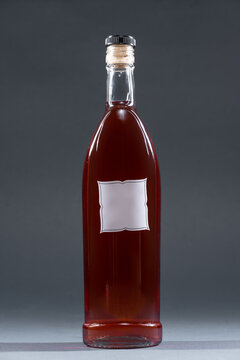 bottle with homemade alcohol tincture or cognac or liquor, mockup with empty label