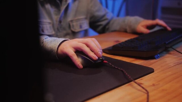 Gamer Using Backlit Keyboard and Mouse During Live Stream