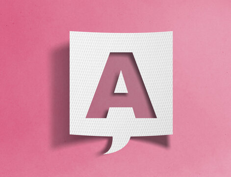 Paper speech bubble with letter A cutout on pink background, alphabet and typography concept
