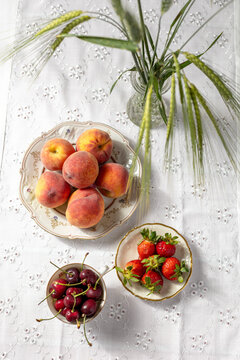 Summer fruit still life with peaches and berries