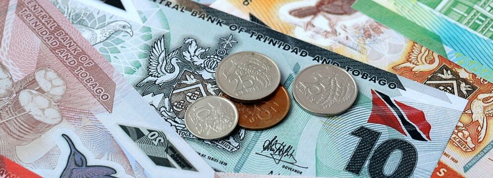 Trinidad and Tobago dollar money and coins on table. Trinidad and Tobago cash bills of TTD currency