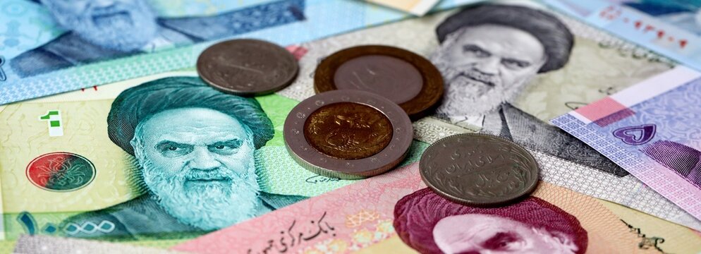 Iranian rial money banknotes and coins on table. Iran cash bills of IRR currency
