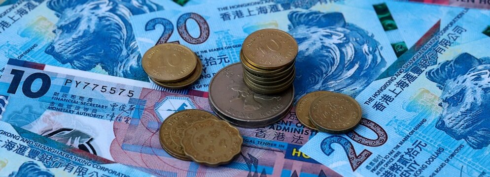 Hong Kong dollar money banknotes and coins on table. Hong Kong cash bills of HKD currency