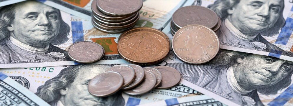 US dollar money 100 banknotes and coins on table. United States cash bills of USD currency