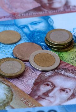 Chilean peso money banknotes and coins on table. Chile cash bills of CLP currency