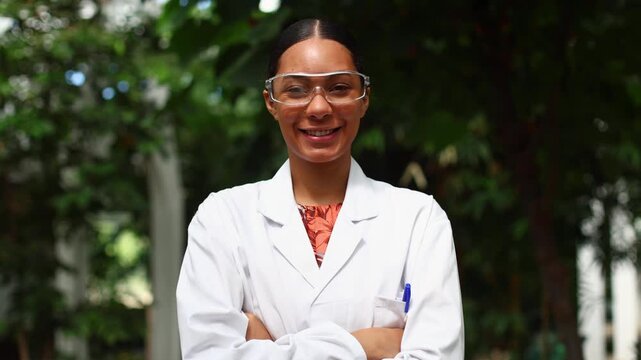 Confident female scientist smiling with arms crossed