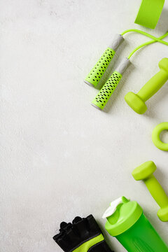 Vertical fitness accessories background with copy space on grey concrete