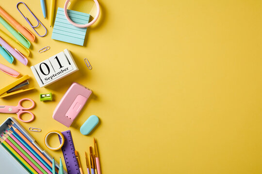 School supplies and September 1 calendar border on yellow background