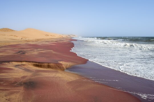 Sandy beach beach with pink sand, Atlantic coast in the Namib Desert, Sandwich Harbour, Namib Naukluft Park, Namib Desert, Namibia