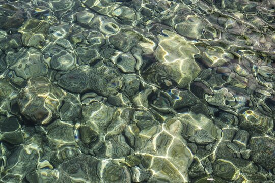 Clear water surface with shimmering stones and light reflections, Stromboli, Aeolian or Lipari Islands, Tyrrhenian Sea, Sicily, Southern Italy, Italy