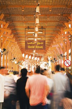 Dubai, UAE - 17th january, 2026: Dubai Gold Souk in Deira. Zoom in timelapse crowds visitors under traditional wooden architecture historic bazaar. Gold industry trade investment background concept