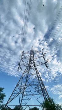 High-voltage steel power pylons and transmission lines stretching across an open landscape in Islamabad, Pakistan. Footage highlighting electricity transmission, power infrastructure, utility networks