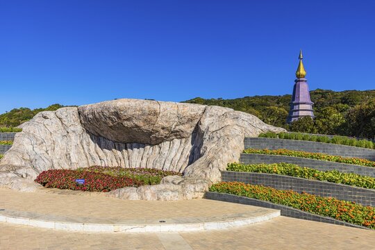 Monumental rock formation in an artfully landscaped garden with the King's Pagoda in the back, Doi Inthanon National Park, Chiang Mai Province, Thailand