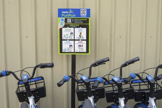 A series of Hello PunPun rental bikes, the blue and white wheels are properly available and show the modern, app-based bike sharing in the historic city center, station in the Phra Nakhon district, Bangkok, Thailand