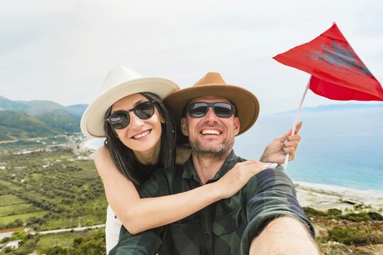 Happy young pretty woman handsome woman tourist enjoying summer holiday in Sarande, Albania - Traveling life style concept taking selfie in Balkans - Tourism and summertime vacation concept