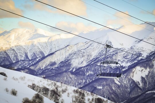 Gudauri six seat blue chair lift with caucasus mountains background. Blank space ski resort closure concept.Gudauri. Georgia