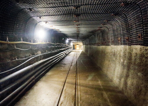 Underground old mine tunnel with railway, mining industry