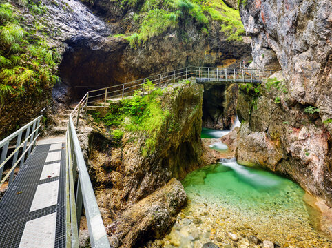 Amazing gorge waterfall landscape (Almbachklamm) in Bavarian Alps with bridge footpath